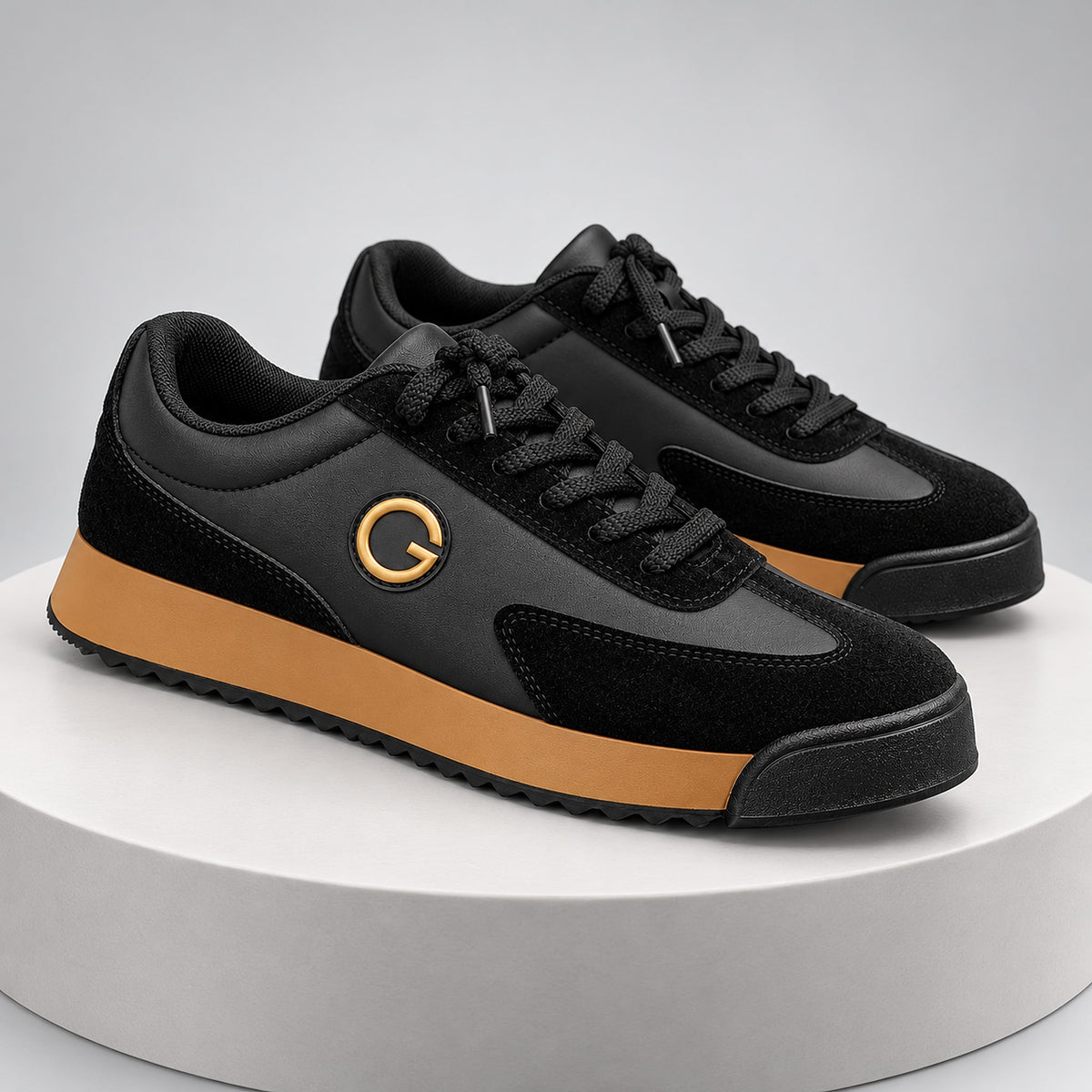 Low-top sneaker with a black upper, tan sole, and gold ring logo detail.