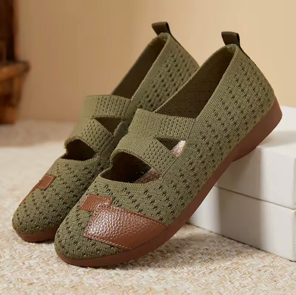 Slip-on shoes in olive green knit with brown soles and pebbled toe overlay.