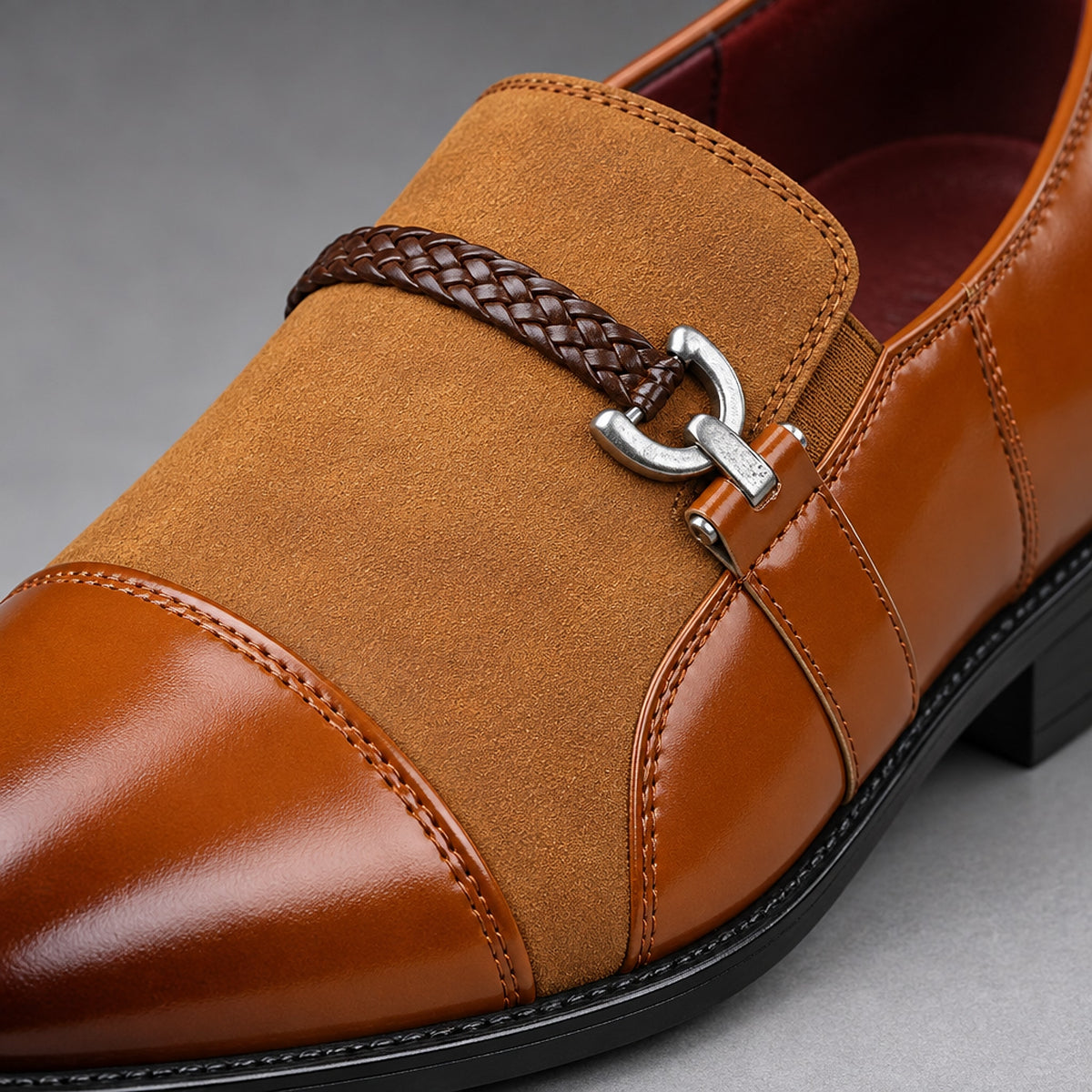 Brown loafers in warm tan with matte suede-look and glossy leather-look panels. (detail macro)