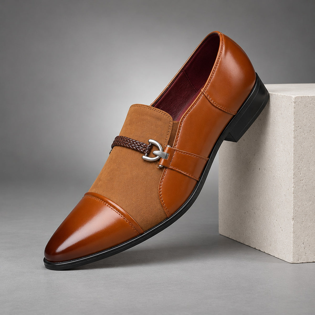 Brown loafers in warm tan with matte suede-look and glossy leather-look panels. (plinth)